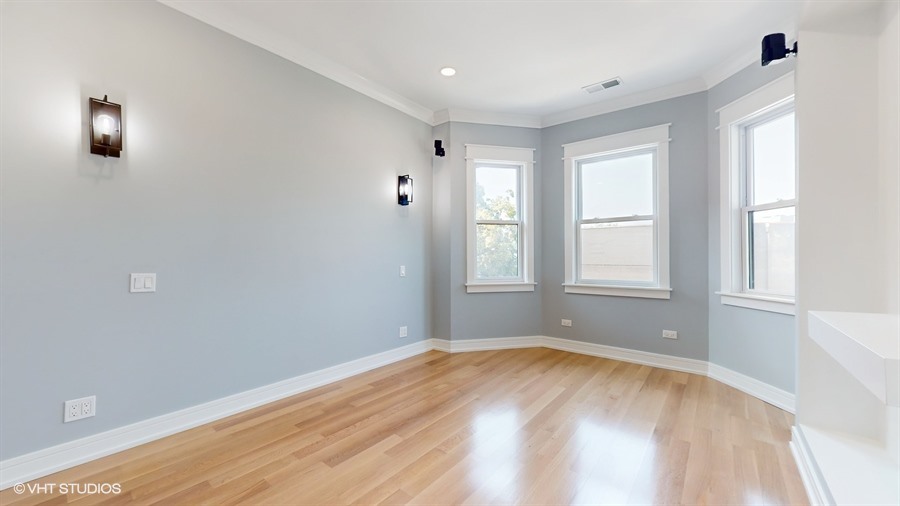 4115 North Ridgeway Avenue Chicago, IL 60618 - Photo 17 of 46 an empty room with wooden floor and windows