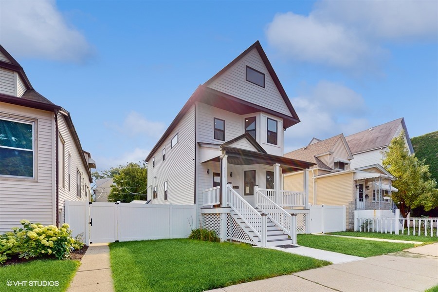 4115 North Ridgeway Avenue Chicago, IL 60618 - Photo 2 of 46 a front view of a house with a yard and trees