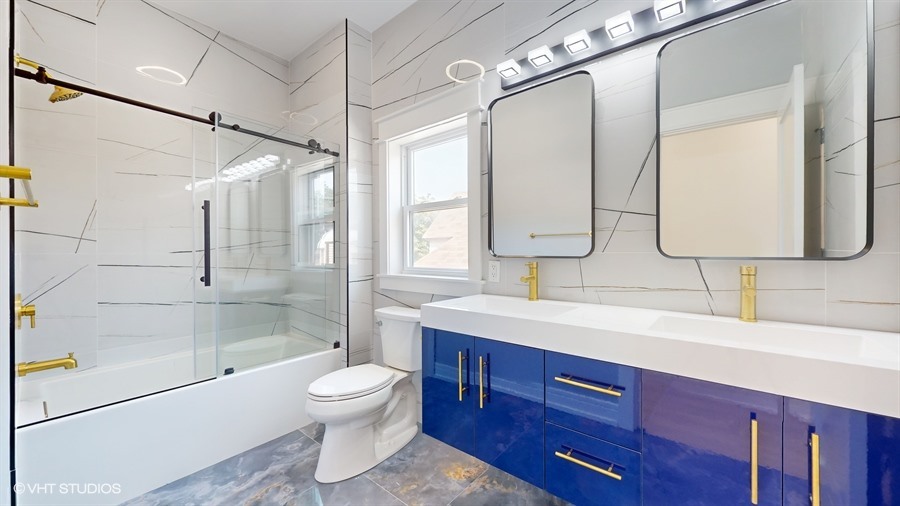 4115 North Ridgeway Avenue Chicago, IL 60618 - Photo 24 of 46 a bathroom with a double vanity sink toilet mirror and shower