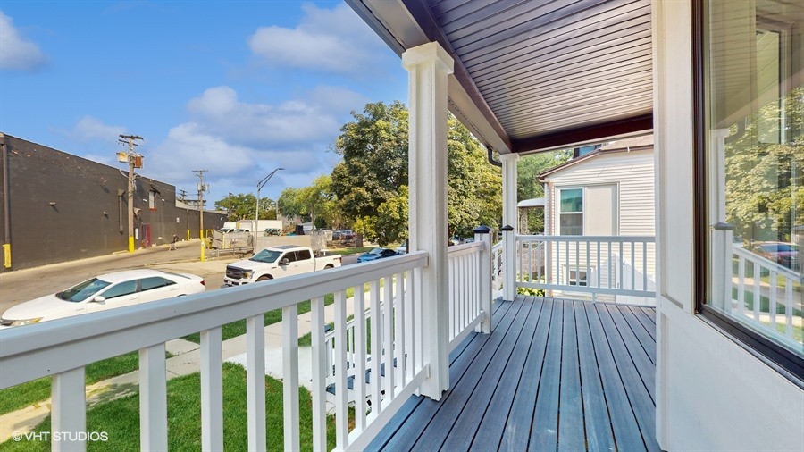 4115 North Ridgeway Avenue Chicago, IL 60618 - Photo 4 of 46 a balcony view with a large window and wooden floor