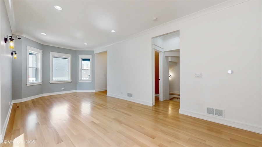 4115 North Ridgeway Avenue Chicago, IL 60618 - Photo 7 of 46 a view of an empty room with wooden floor and a window