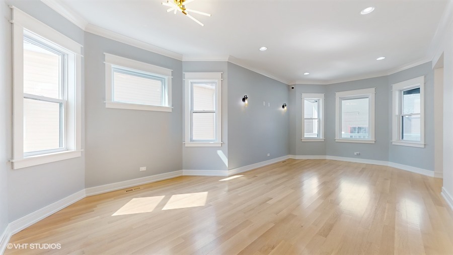 4115 North Ridgeway Avenue Chicago, IL 60618 - Photo 8 of 46 a view of empty room with wooden floor and fan
