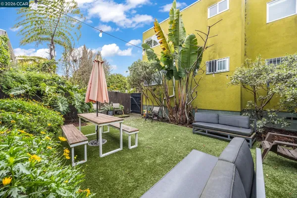 a view of a chair and tables in the backyard of a house