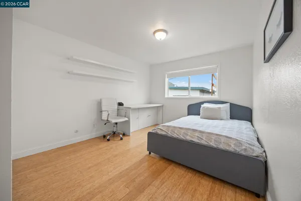 a bedroom with a bed and window