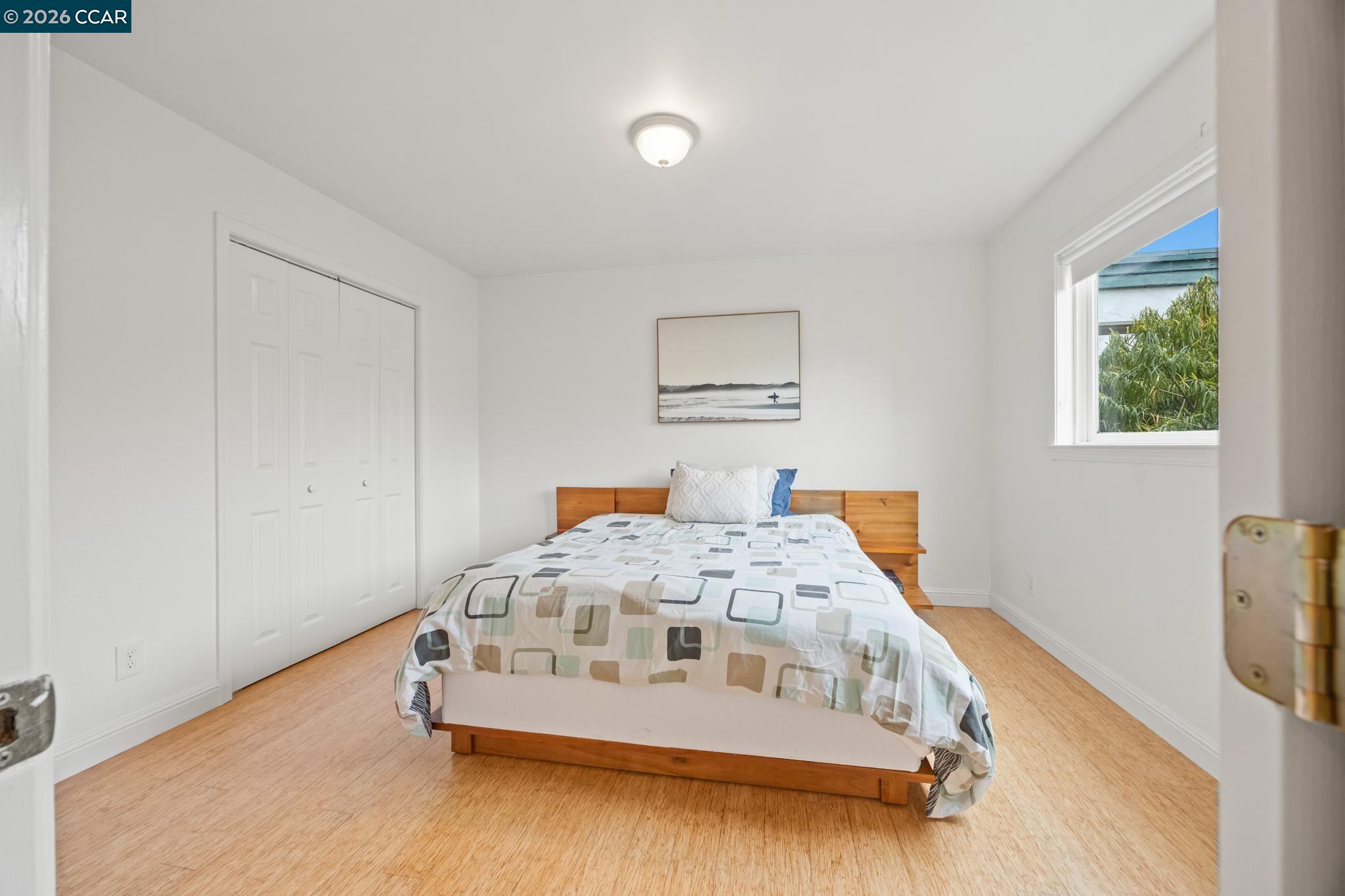 2327 Tenth Street, Unit 4 Berkeley, CA 94710 - Photo 19 of 39 a white bed sitting in a bedroom next to a window