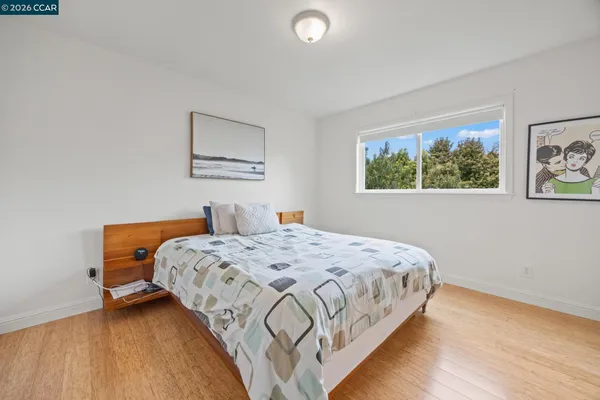 a bedroom with bed and a window