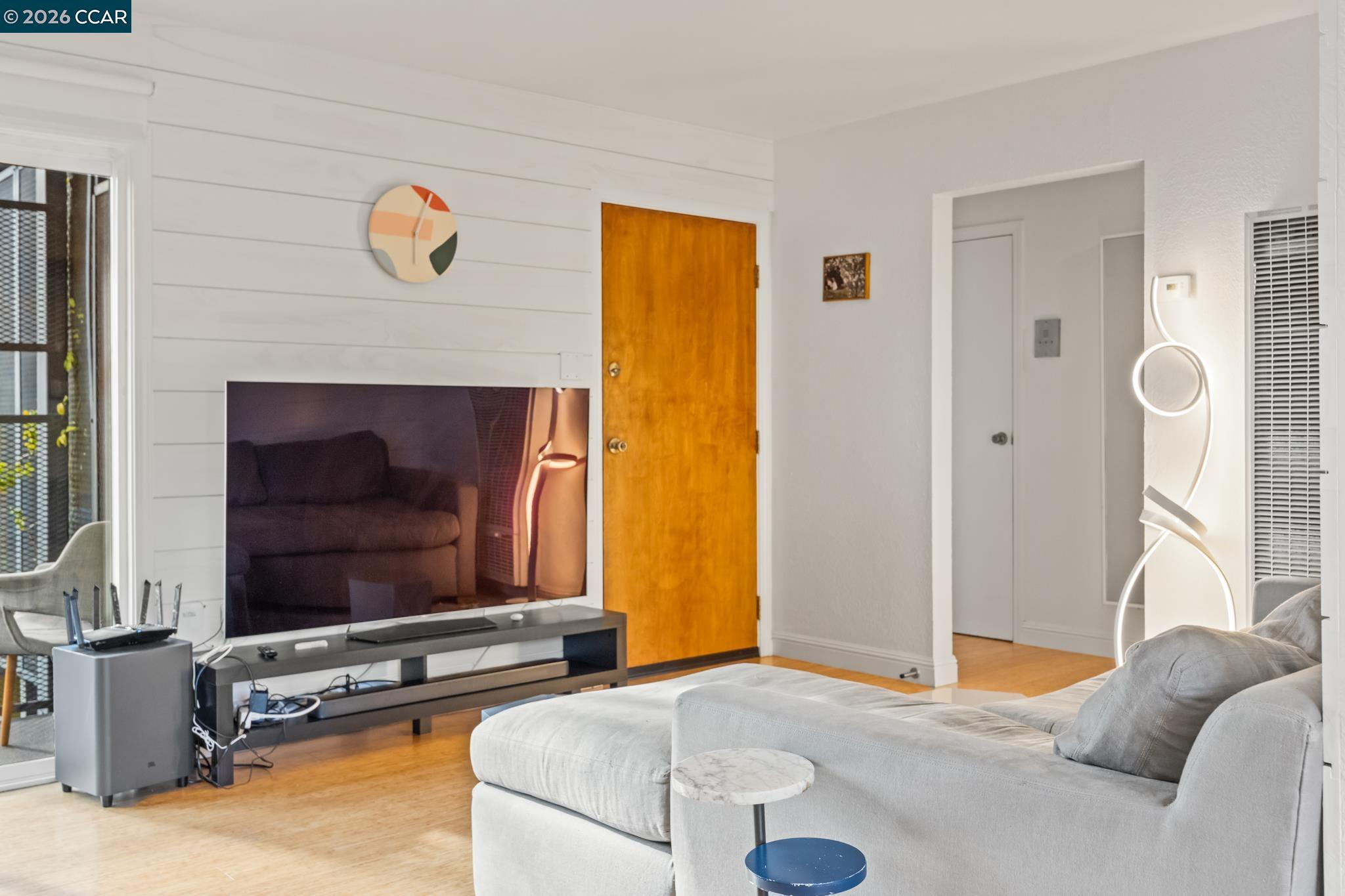 2327 Tenth Street, Unit 4 Berkeley, CA 94710 - Photo 7 of 39 a living room with furniture and a flat screen tv