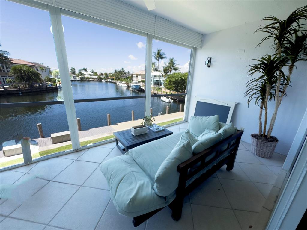 2330 Northeast 36th Street, Unit 11 Lighthouse Point, FL 33064 - Photo 3 of 11 a view of swimming pool with outdoor seating and plants