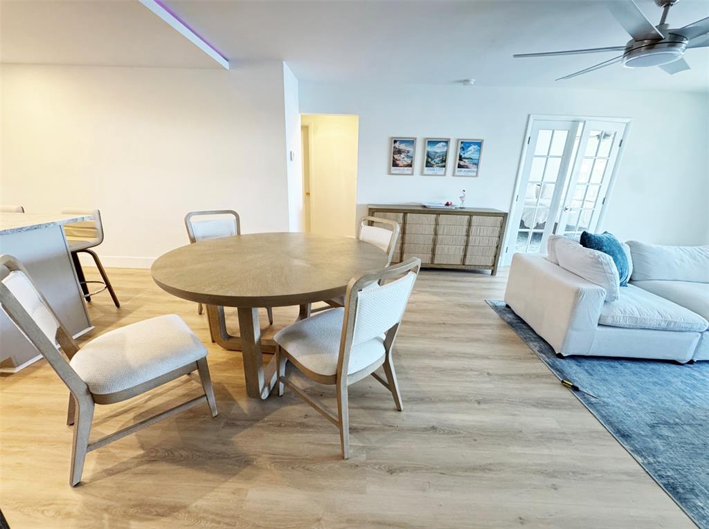 2330 Northeast 36th Street, Unit 11 Lighthouse Point, FL 33064 - Photo 6 of 11 a living room with furniture and a wooden floor