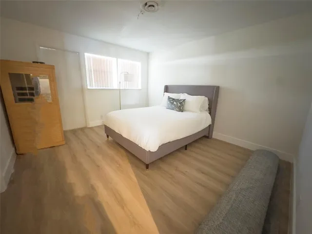 a bedroom with a bed and window