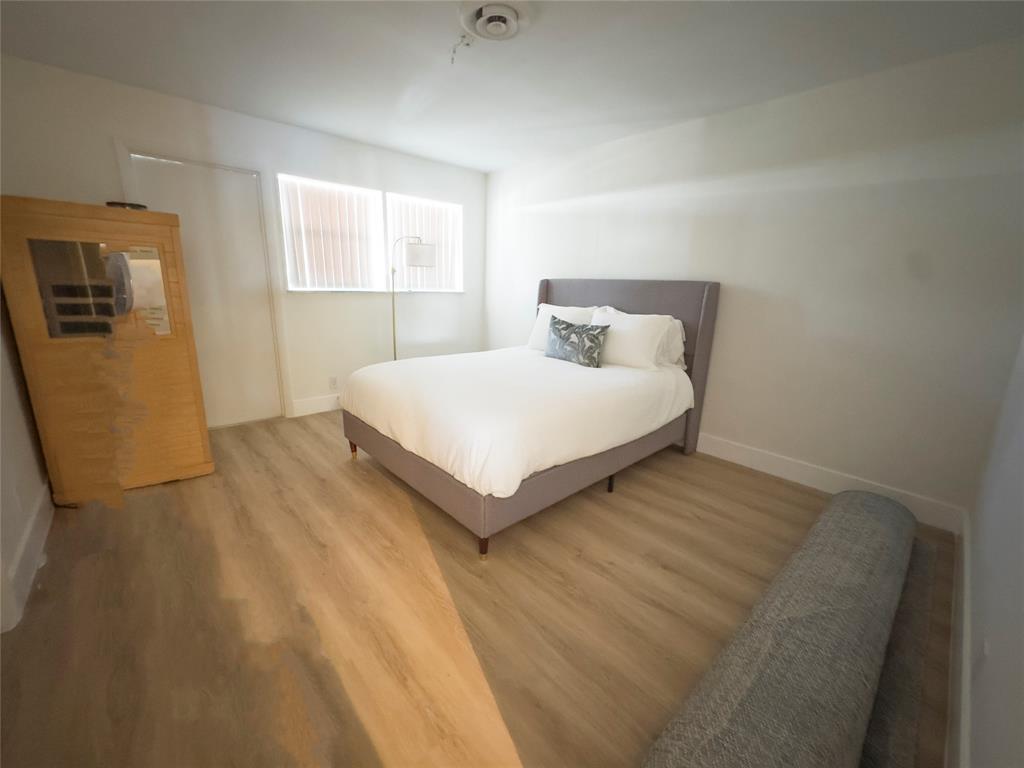 2330 Northeast 36th Street, Unit 11 Lighthouse Point, FL 33064 - Photo 7 of 11 a bedroom with a bed and window