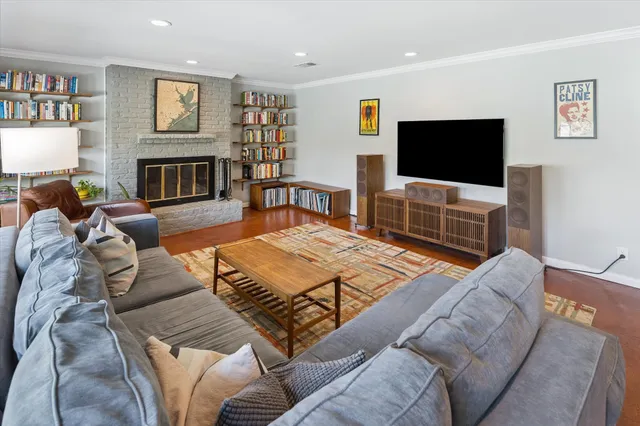 a dining room with wooden floor a glass table and chairs