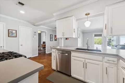 a kitchen with a cabinets and chairs