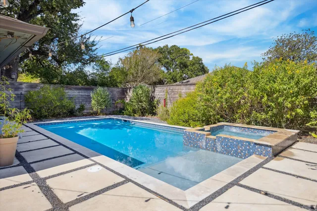 a view of a pool in a backyard
