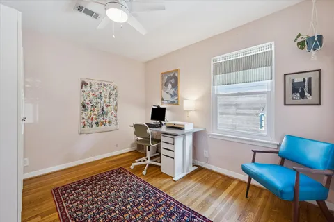 a bedroom with a bed chandelier and a window