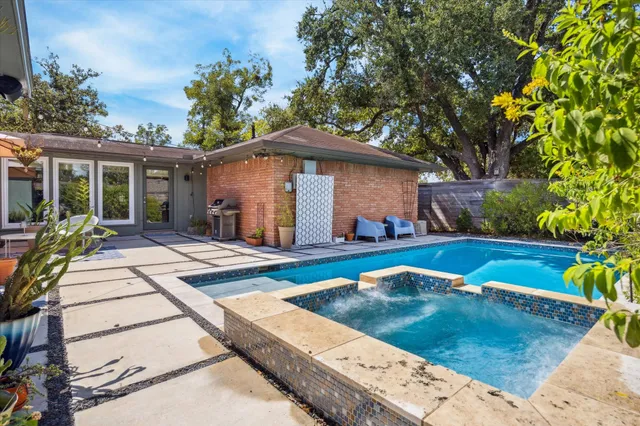 a view of a patio with a dining table and chairs under an umbrella