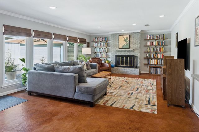 a living room with fireplace furniture and a flat screen tv