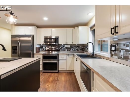 76500 Delena Mayger Road Rainier, OR 97048 - Photo 5 of 24 a kitchen with kitchen island granite countertop stainless steel appliances and sink