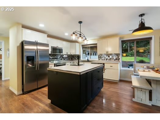 76500 Delena Mayger Road Rainier, OR 97048 - Photo 6 of 24 a kitchen with kitchen island a sink stainless steel appliances and cabinets