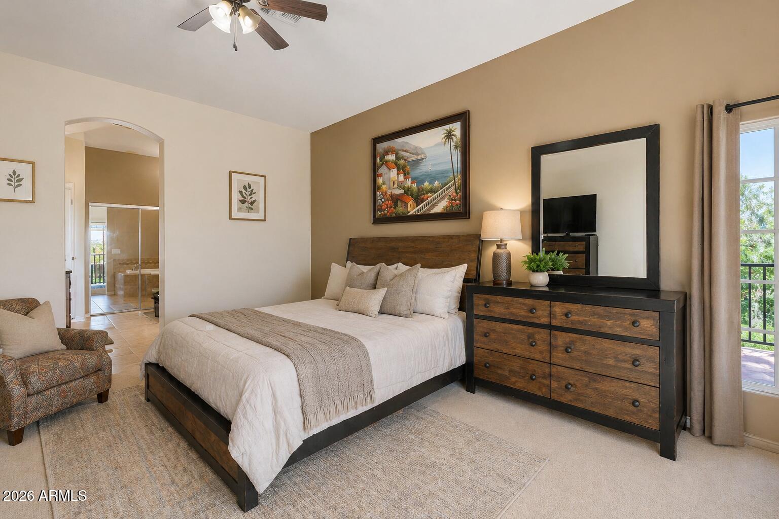 6202 East McKellips Road, Unit 11 Mesa, AZ 85215 - Photo 13 of 21 a bedroom with a bed and a chandelier