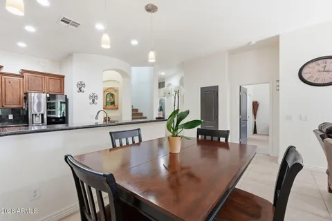 a bedroom with a large bed and a chandelier fan