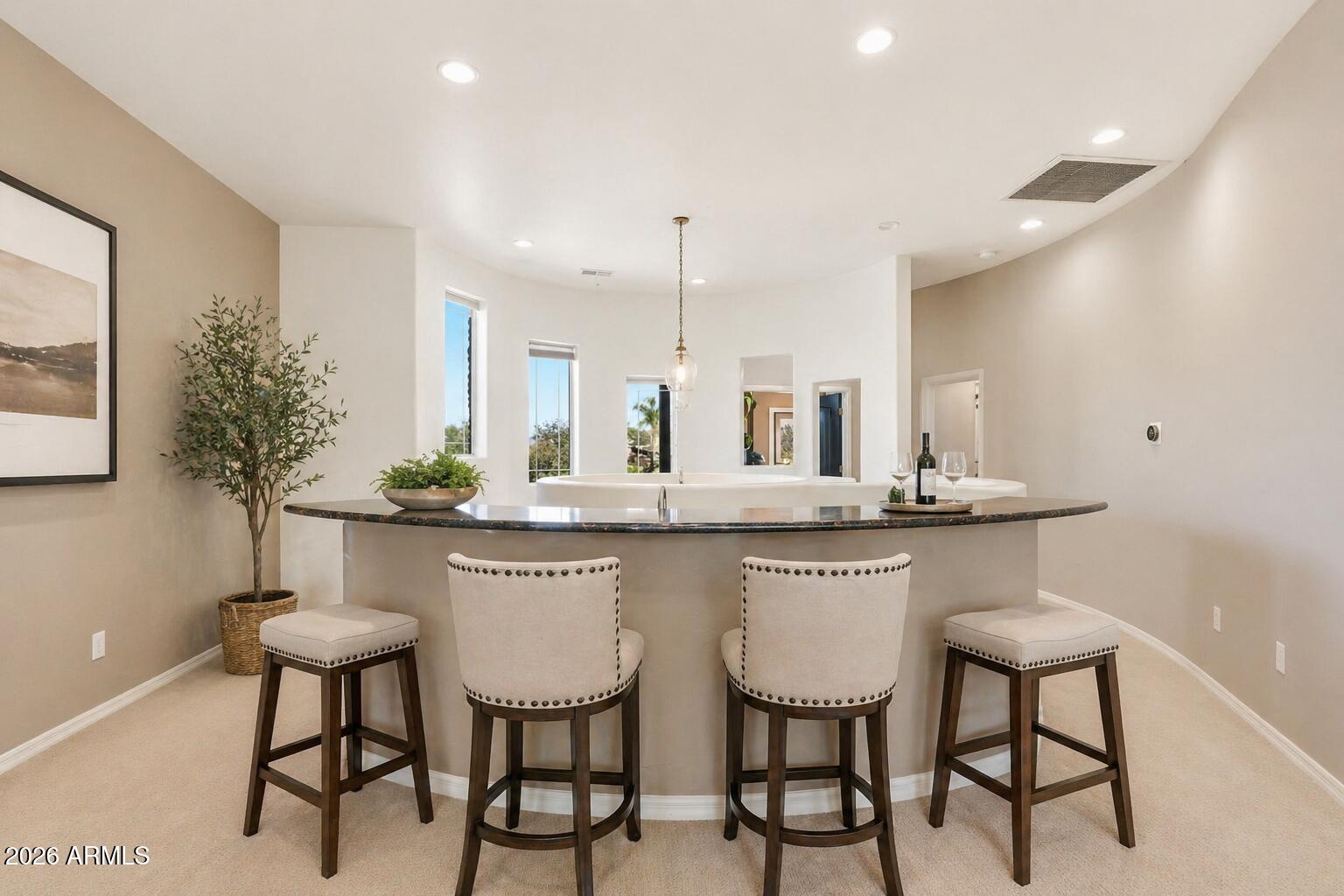 6202 East McKellips Road, Unit 11 Mesa, AZ 85215 - Photo 16 of 21 a kitchen with stainless steel appliances a table and chairs in it