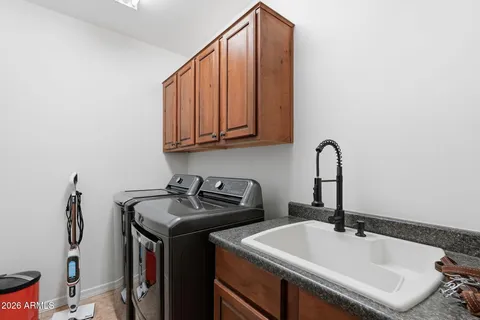 a bathroom with double vanity sinks and a mirror