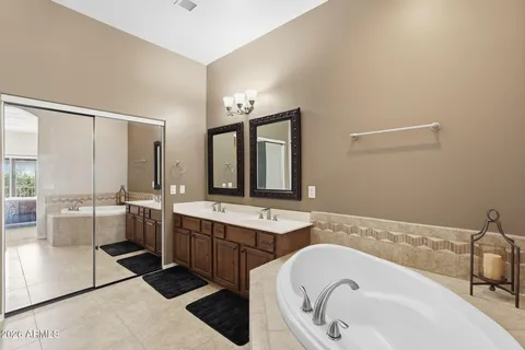 a kitchen with stainless steel appliances granite countertop a stove a sink dishwasher and a dining table with wooden floor