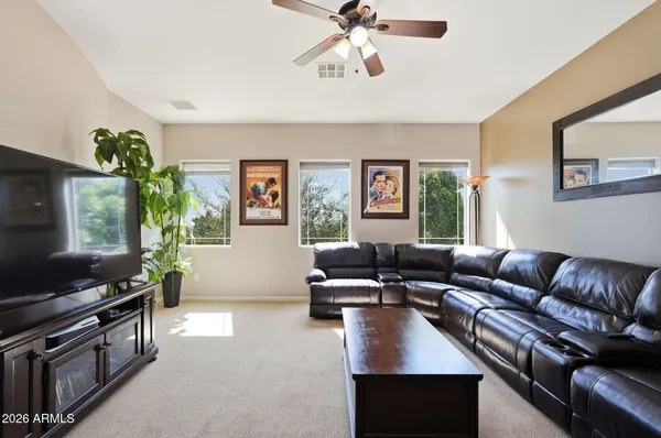 a room with furniture pool table and wooden floor