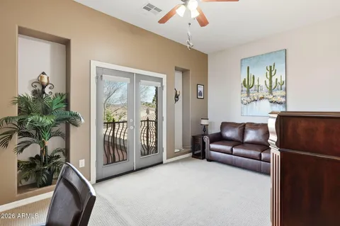 a living room with furniture a projector and a potted plant