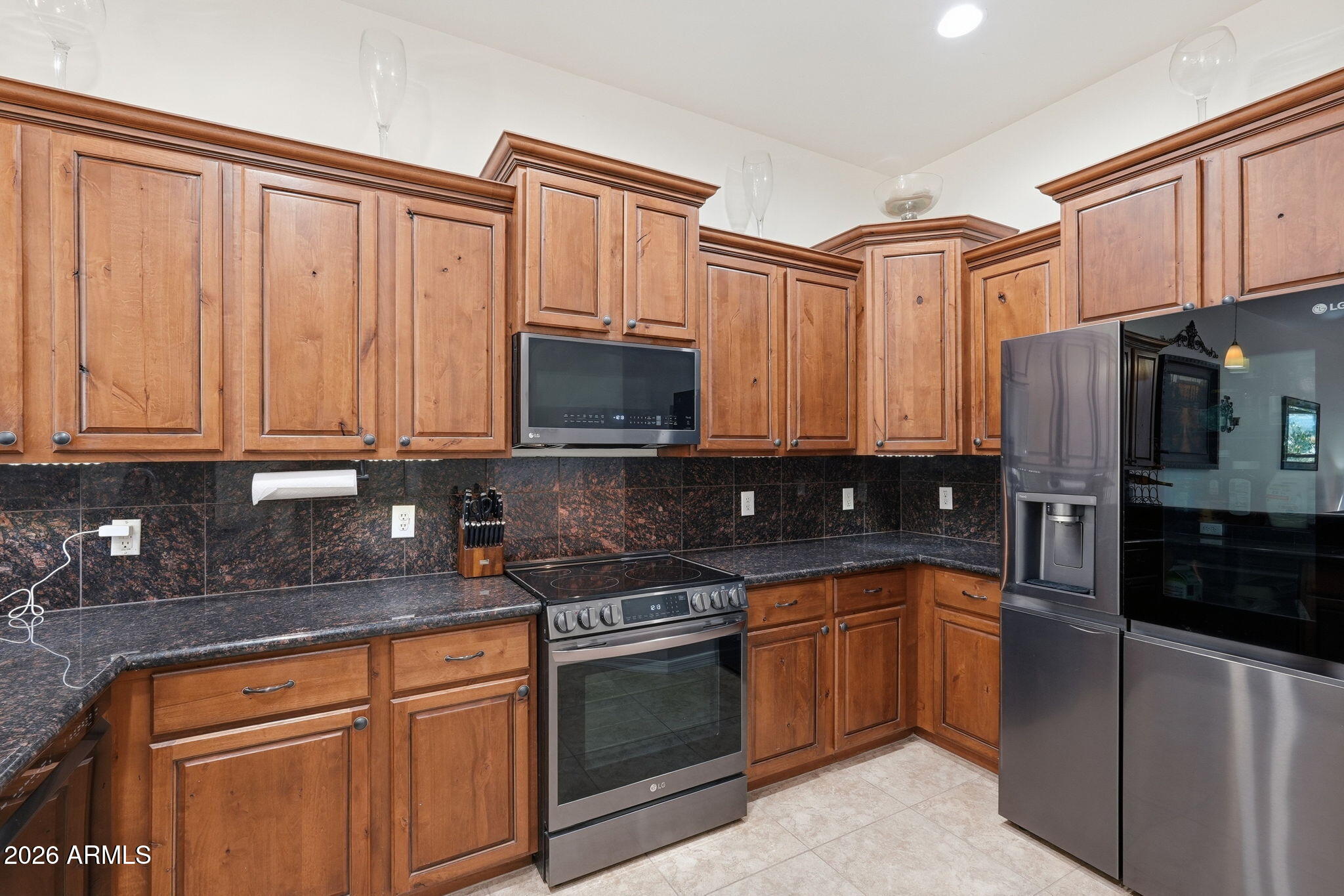 6202 East McKellips Road, Unit 11 Mesa, AZ 85215 - Photo 6 of 21 a kitchen with stainless steel appliances granite countertop a stove a sink dishwasher and a refrigerator
