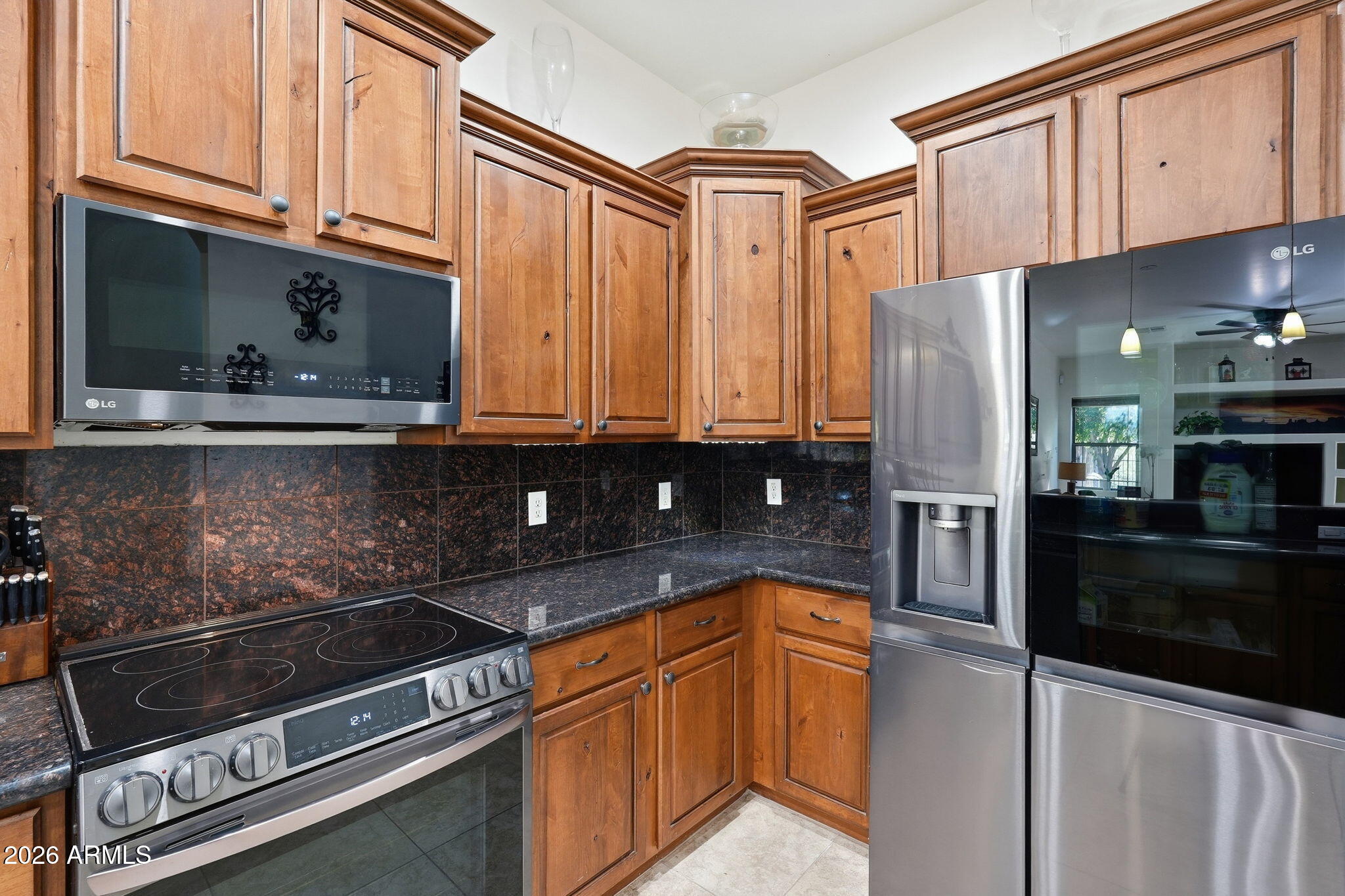 6202 East McKellips Road, Unit 11 Mesa, AZ 85215 - Photo 8 of 21 a kitchen with stainless steel appliances granite countertop a refrigerator and a stove top oven