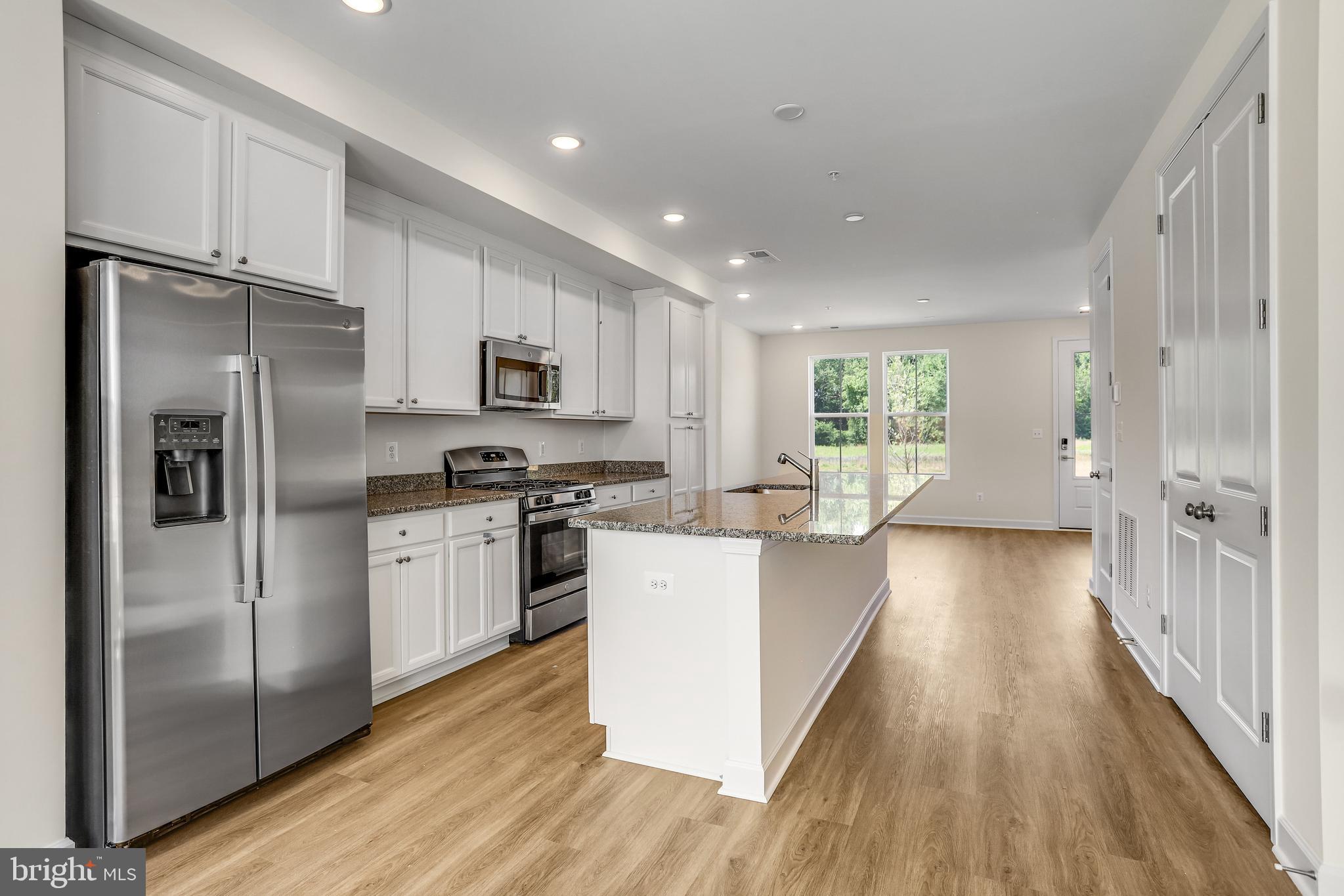 1811 Shookstown Road Frederick, MD 21702 - Photo 12 of 37 a kitchen with a refrigerator a sink and a stove top oven