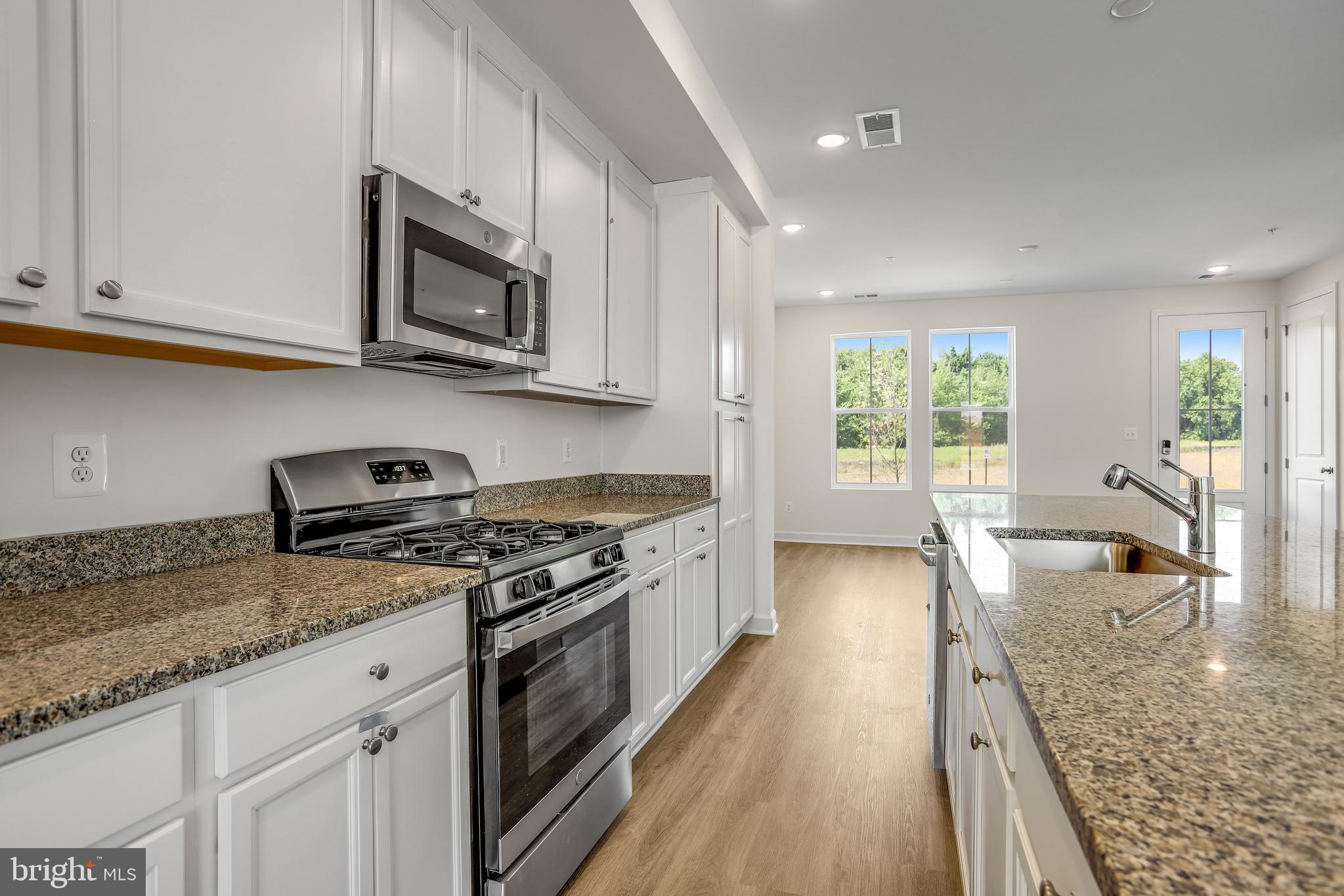 1811 Shookstown Road Frederick, MD 21702 - Photo 14 of 37 a kitchen with stainless steel appliances granite countertop a stove a sink and a microwave