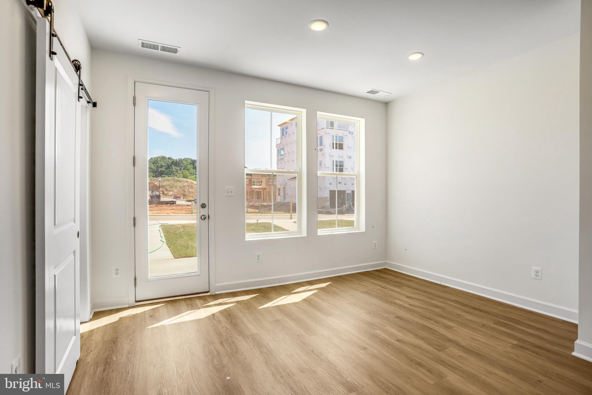 1811 Shookstown Road Frederick, MD 21702 - Photo 15 of 37 a view of an empty room with wooden floor and a window