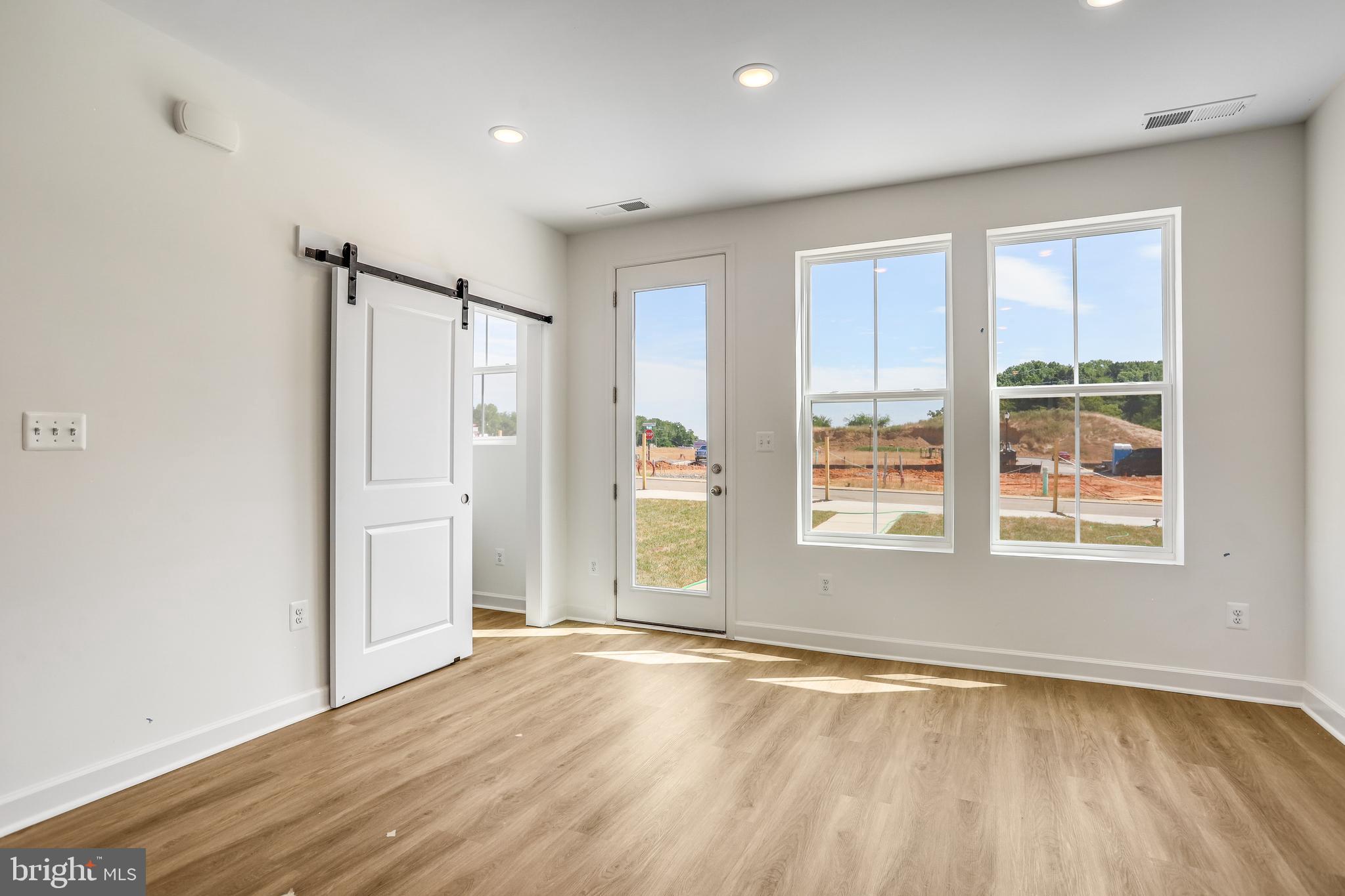 1811 Shookstown Road Frederick, MD 21702 - Photo 16 of 37 an empty room with wooden floor and windows