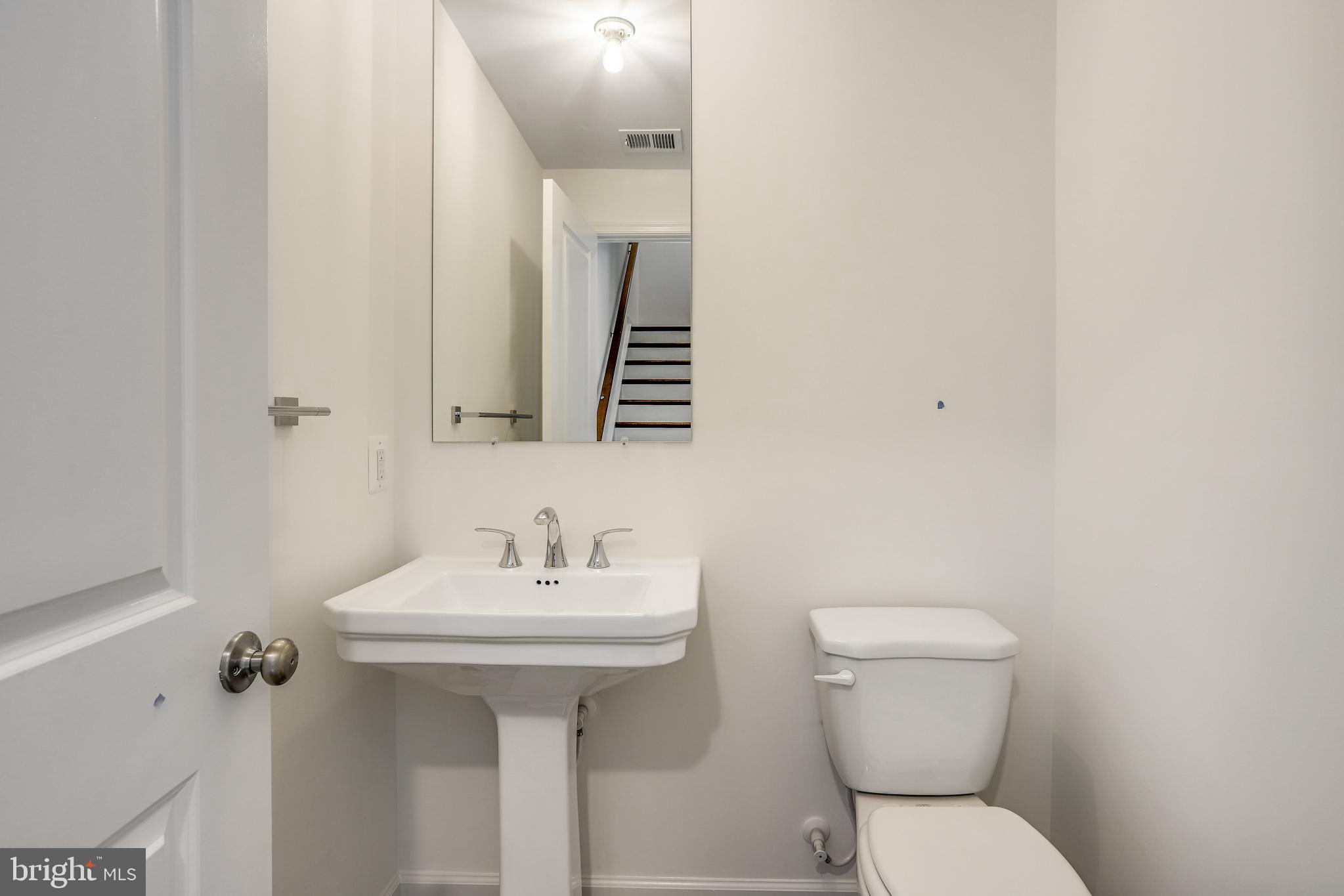 1811 Shookstown Road Frederick, MD 21702 - Photo 18 of 37 a bathroom with a toilet sink and mirror