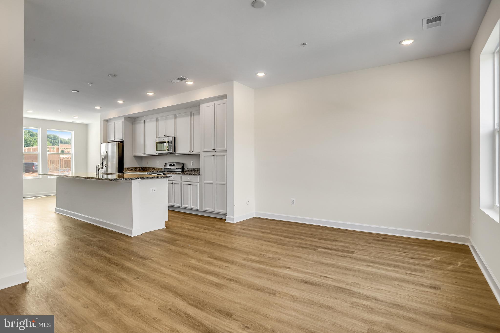 1811 Shookstown Road Frederick, MD 21702 - Photo 2 of 37 a view of kitchen with kitchen island wooden floor center island and stainless steel appliances