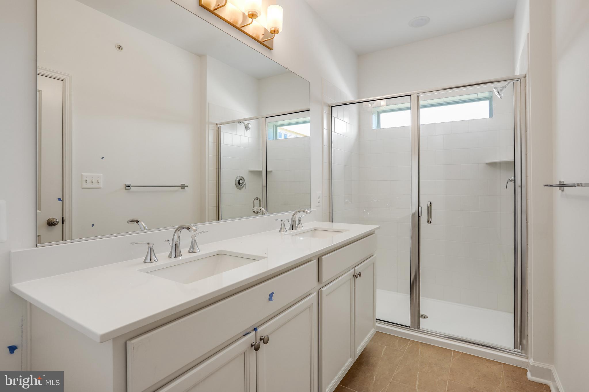 1811 Shookstown Road Frederick, MD 21702 - Photo 24 of 37 a bathroom with a sink mirror and a shower