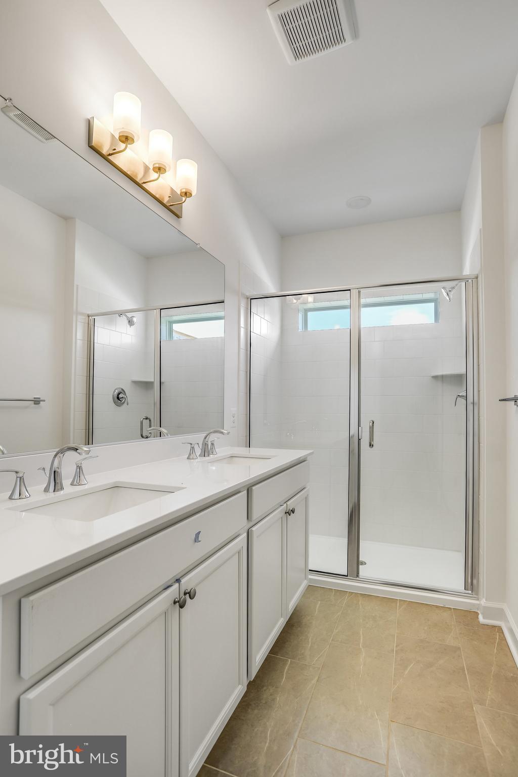 1811 Shookstown Road Frederick, MD 21702 - Photo 25 of 37 a bathroom with a double vanity sink and a mirror