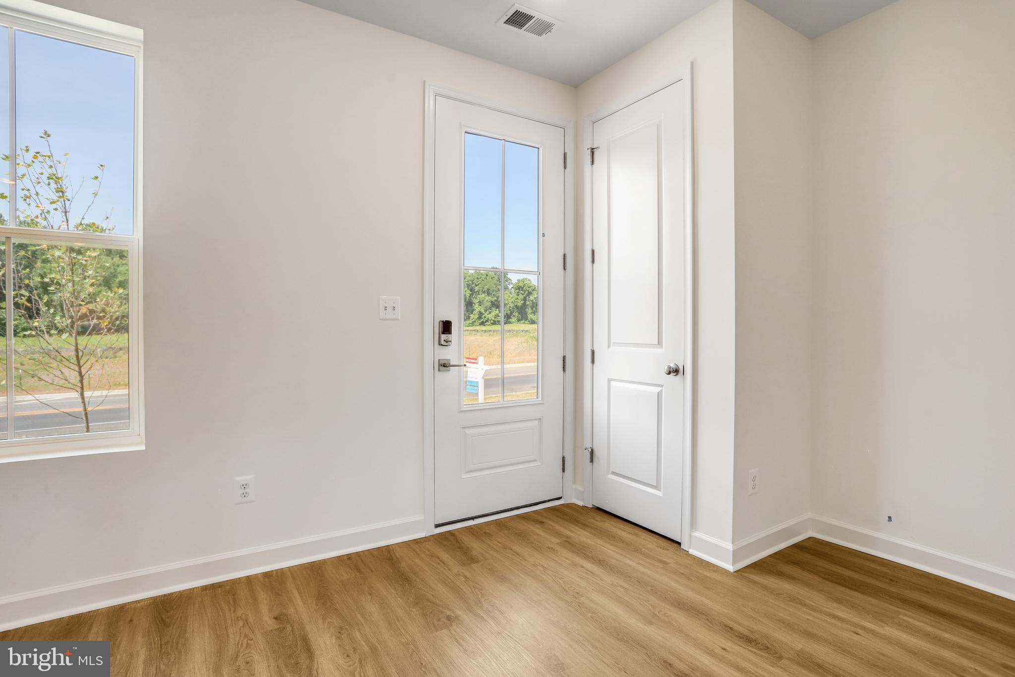 1811 Shookstown Road Frederick, MD 21702 - Photo 3 of 37 a view of an empty room with wooden floor and a window