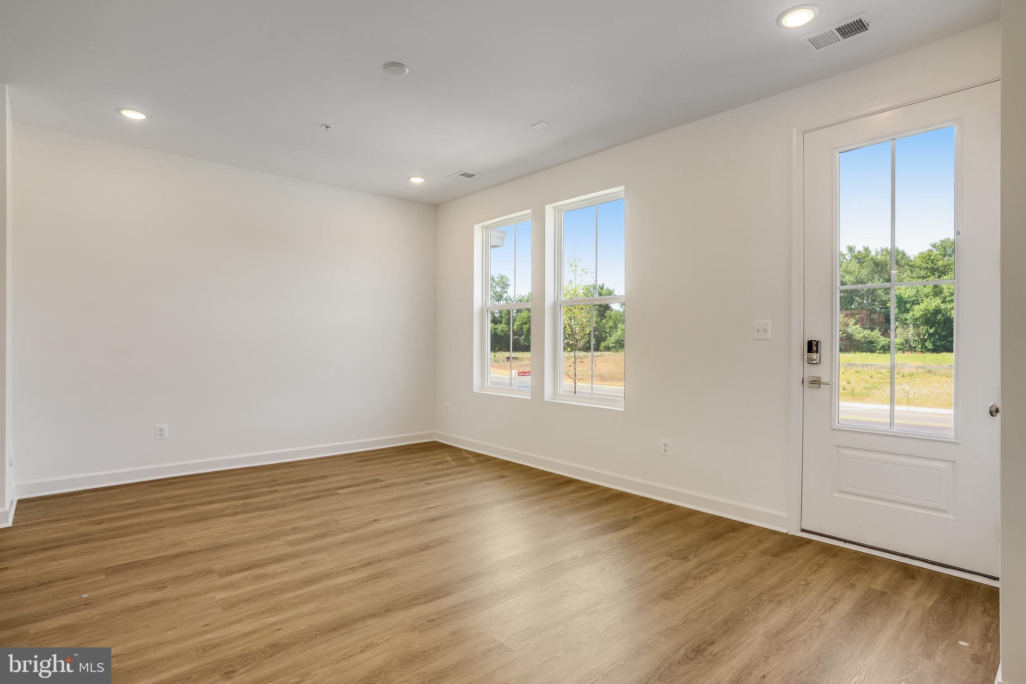1811 Shookstown Road Frederick, MD 21702 - Photo 4 of 37 a view of an empty room with wooden floor and a window