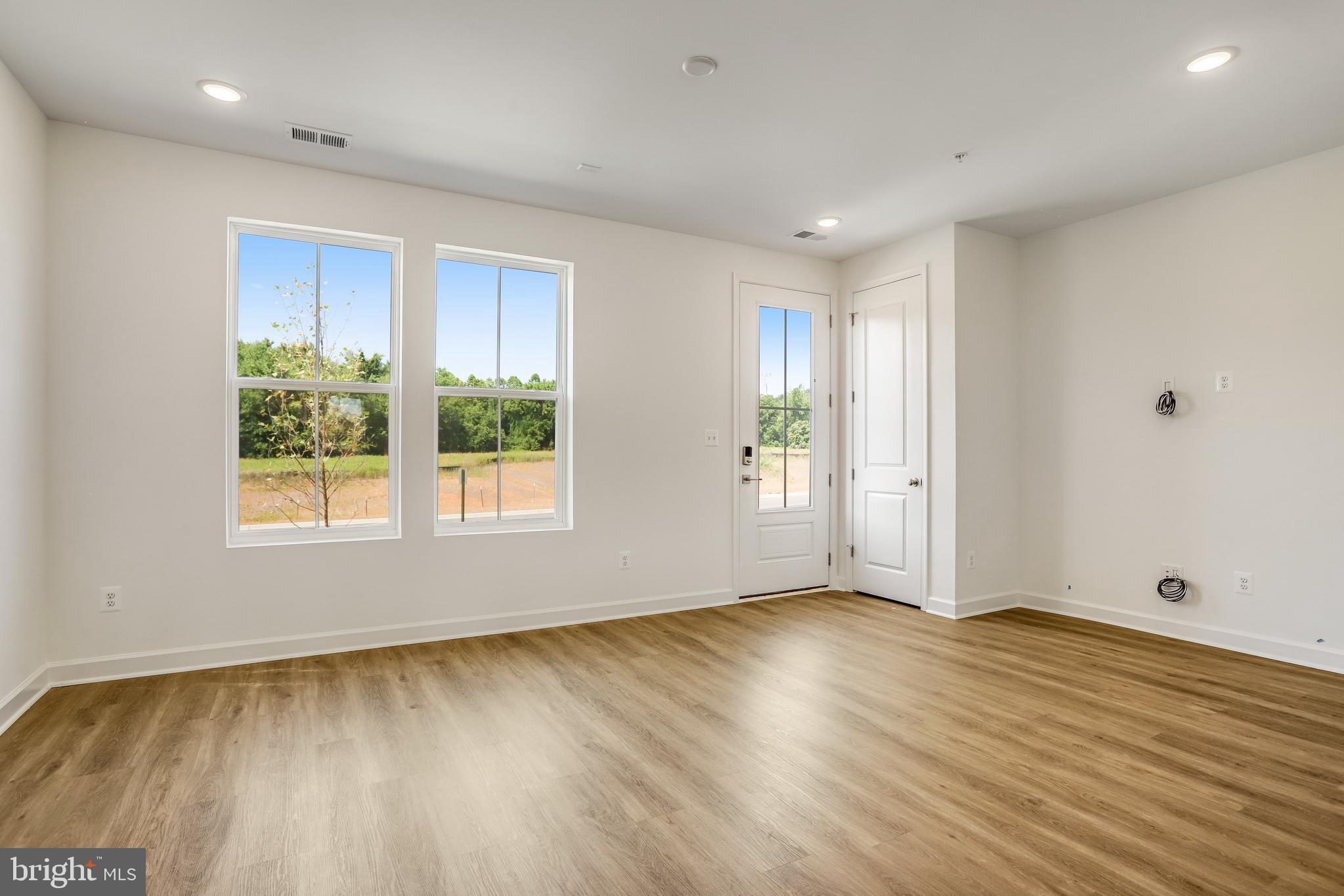 1811 Shookstown Road Frederick, MD 21702 - Photo 5 of 37 a view of an empty room with wooden floor and a window