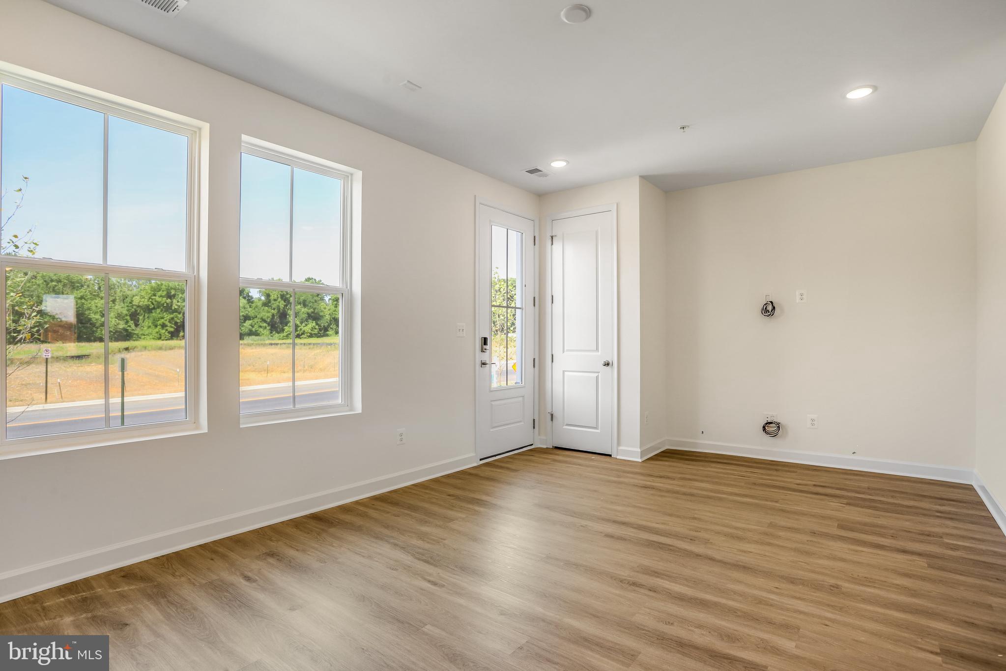 1811 Shookstown Road Frederick, MD 21702 - Photo 6 of 37 a view of an empty room with wooden floor and a window