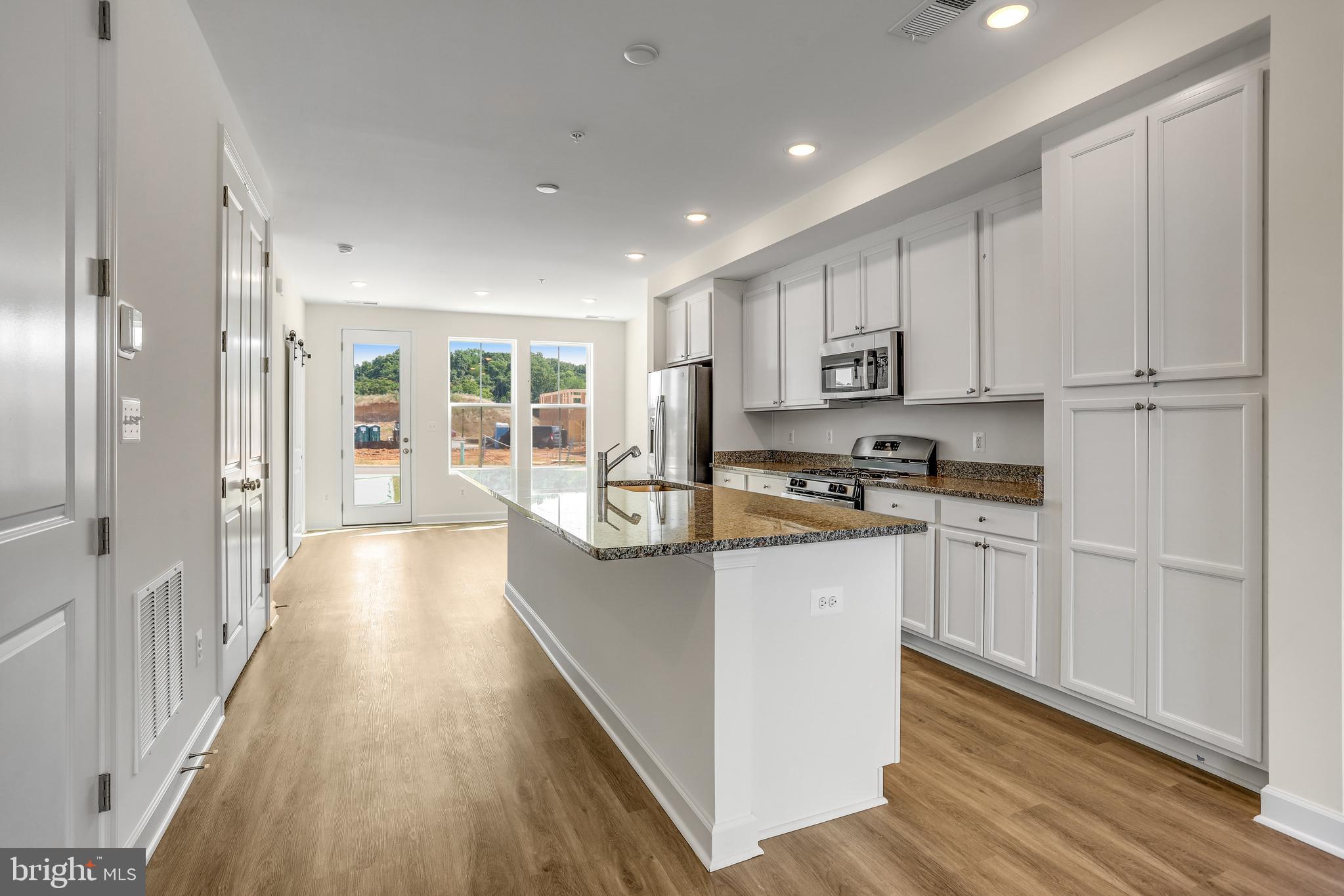 1811 Shookstown Road Frederick, MD 21702 - Photo 9 of 37 a kitchen with stainless steel appliances granite countertop a stove a sink and a refrigerator