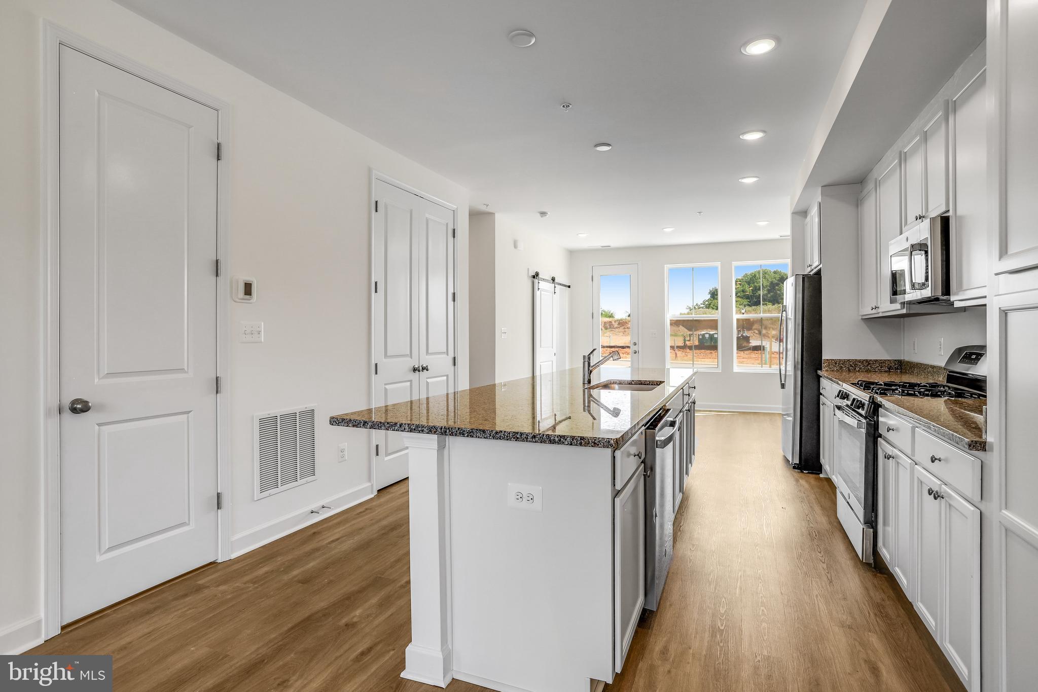 1811 Shookstown Road Frederick, MD 21702 - Photo 10 of 37 a kitchen with granite countertop a sink stove and cabinets