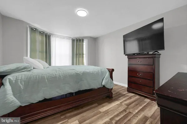a bedroom with a bed and a television