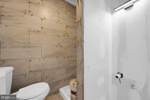 a white toilet sitting next to a shower curtain