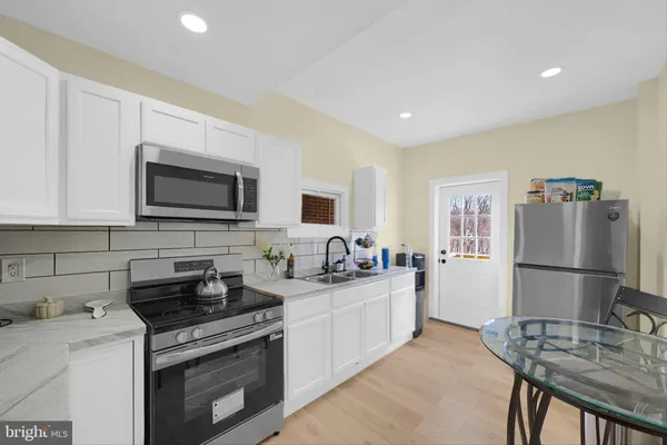 a kitchen with a sink a stove and refrigerator
