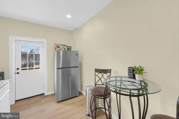 a kitchen with stainless steel appliances a refrigerator and a table